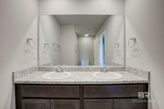 bathroom with vanity and toilet