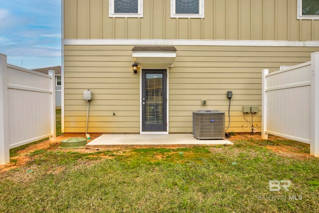 back of house with a yard, a patio, and central air condition unit