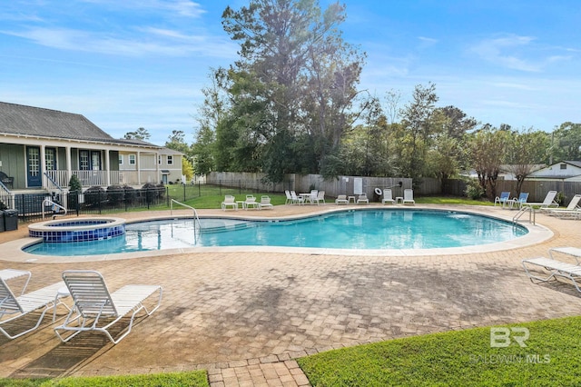 view of pool with a patio area and a community hot tub