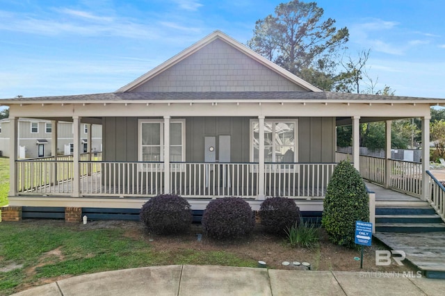 back of property with a porch