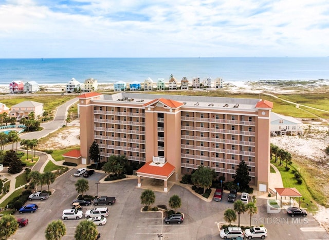 exterior space featuring uncovered parking and a water view