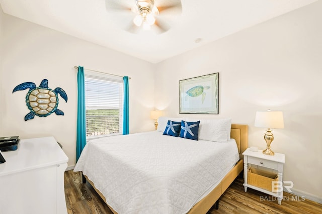 bedroom with wood finished floors, a ceiling fan, and baseboards