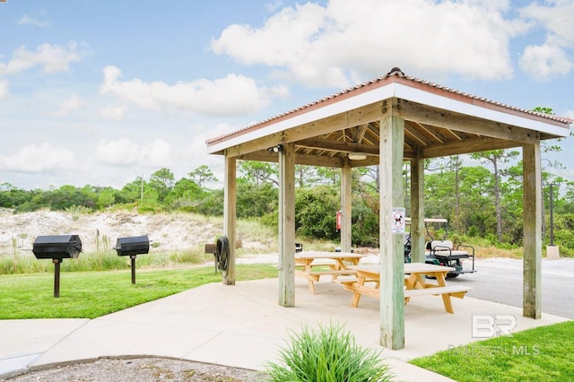 view of community with a patio area, a lawn, and a gazebo