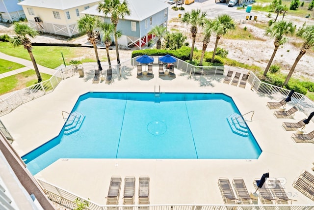 community pool featuring fence and a patio