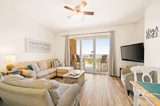 living room with ceiling fan and light wood finished floors