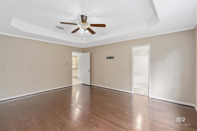 25779 Austin Rd, Daphne, AL 36526 - unfurnished bedroom featuring a tray ceiling, hardwood / wood-style flooring, baseboards, ensuite bathroom, and ornamental molding
