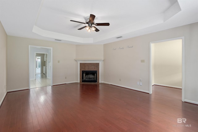 25779 Austin Rd, Daphne, AL 36526 - unfurnished living room with a raised ceiling, a ceiling fan, wood finished floors, and baseboards