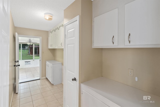 25779 Austin Rd, Daphne, AL 36526 - laundry room featuring light tile patterned flooring, ceiling fan, a textured ceiling, cabinet space, and an AC wall unit