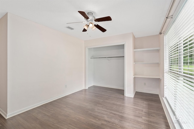 25779 Austin Rd, Daphne, AL 36526 - unfurnished bedroom featuring dark wood-type flooring, baseboards, a closet, and a ceiling fan