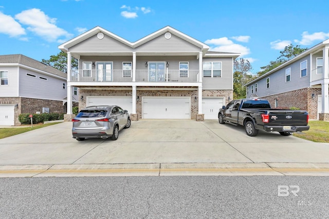 view of front of home with a garage and a balcony