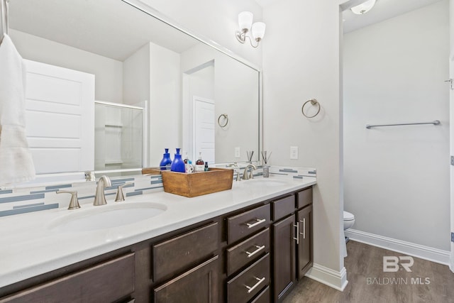 bathroom featuring vanity, hardwood / wood-style flooring, toilet, and an enclosed shower