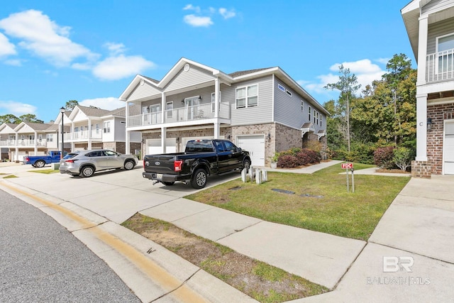 multi unit property with a front yard, a balcony, and a garage