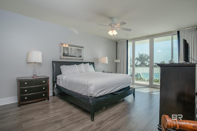 bedroom featuring ceiling fan, expansive windows, access to exterior, and wood-type flooring