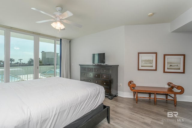 bedroom featuring light wood-type flooring, ceiling fan, and access to exterior