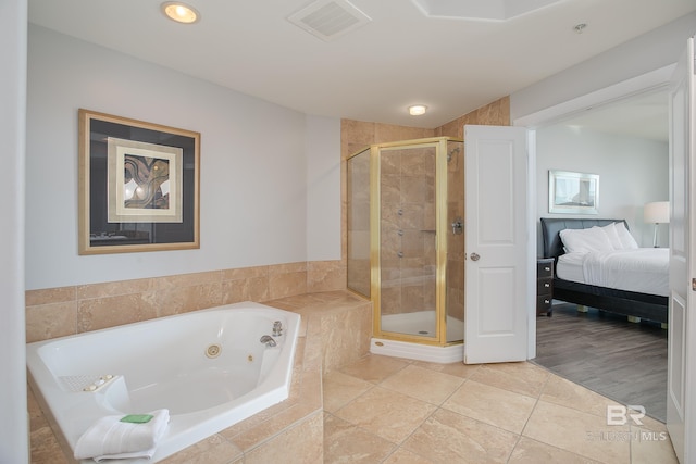 bathroom with shower with separate bathtub and wood-type flooring