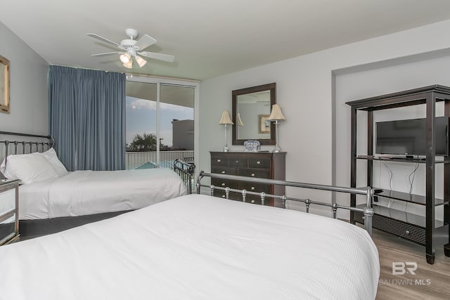 bedroom featuring ceiling fan, access to exterior, and hardwood / wood-style flooring