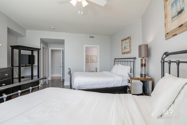 bedroom with ceiling fan, ensuite bathroom, and wood-type flooring