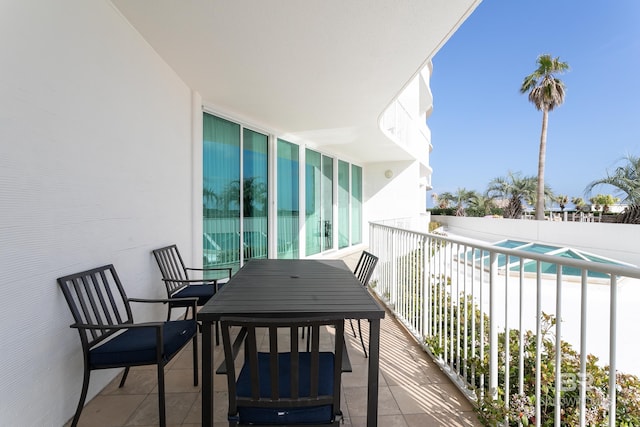 balcony featuring a fenced in pool