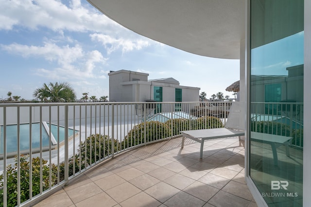 balcony featuring a community pool