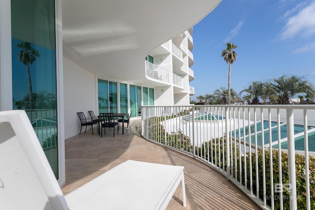 balcony with a fenced in pool