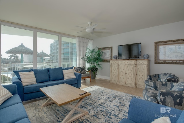 tiled living room with plenty of natural light and ceiling fan