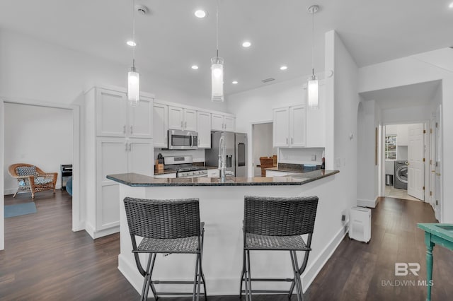 1352 W Fairway Dr, Gulf Shores, AL 36542 - kitchen featuring dark wood finished floors, stainless steel appliances, baseboards, white cabinetry, and a peninsula