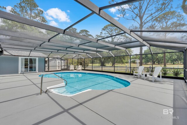 1352 W Fairway Dr, Gulf Shores, AL 36542 - outdoor pool featuring a patio area, a lanai, and a storage shed
