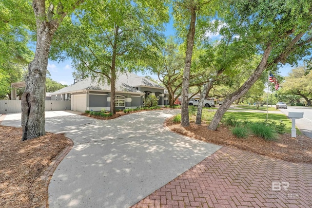 1352 W Fairway Dr, Gulf Shores, AL 36542 - view of front facade with stucco siding, a garage, fence, and driveway