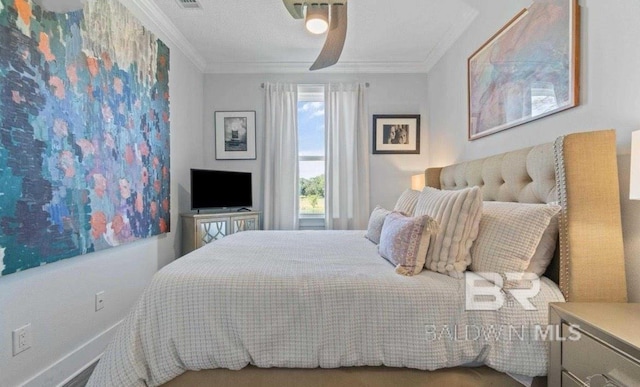 bedroom featuring a ceiling fan and crown molding