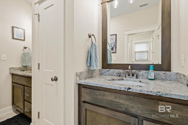 bathroom with tile patterned floors, visible vents, and vanity