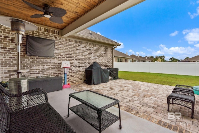 view of patio featuring grilling area, a ceiling fan, and fence