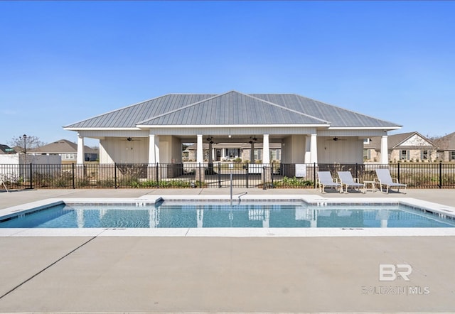 community pool featuring a patio, a ceiling fan, and fence