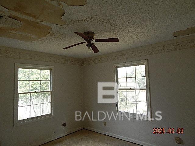 spare room featuring a ceiling fan