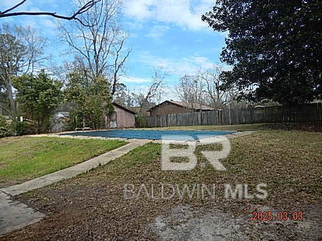 view of pool with a fenced in pool, a yard, and fence