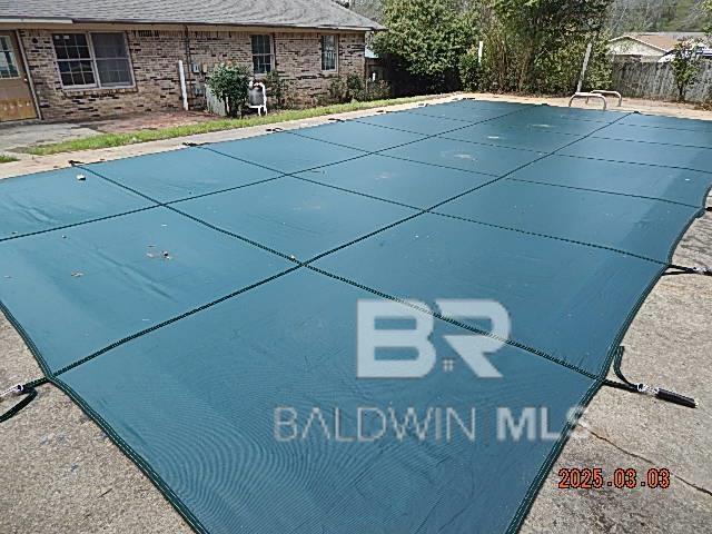 view of swimming pool featuring a fenced in pool