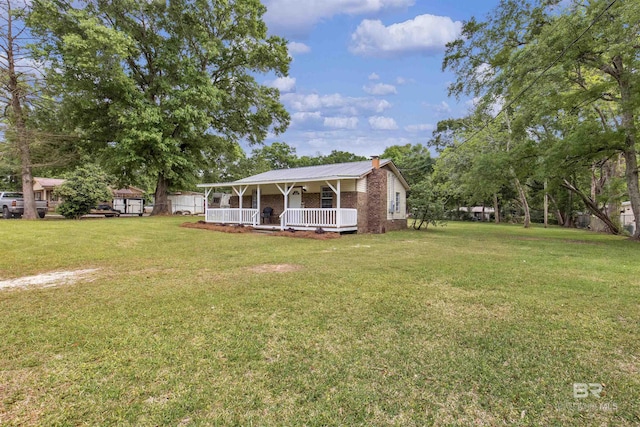 9241 Vallaris St, Mobile, AL 36608 - view of front of property with a front yard, a porch, a chimney, and metal roof
