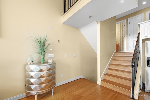 staircase with wood-type flooring