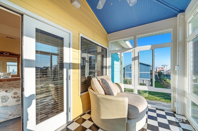 sunroom featuring ceiling fan, vaulted ceiling, and a wealth of natural light