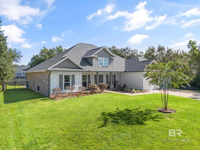 craftsman house with a front lawn and a garage