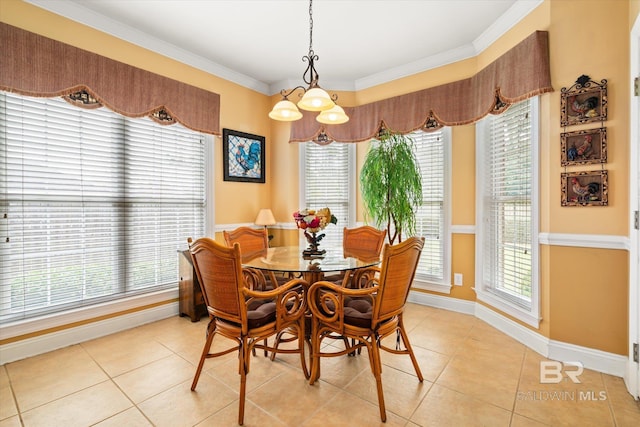 dining area featuring crown molding, light tile patterned floors, and baseboards