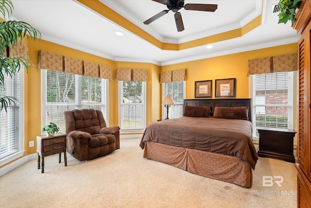 carpeted bedroom with recessed lighting, multiple windows, a raised ceiling, and ornamental molding