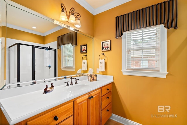 full bathroom with vanity, a shower stall, crown molding, and baseboards