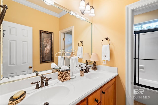 full bath with double vanity, a sink, and ornamental molding