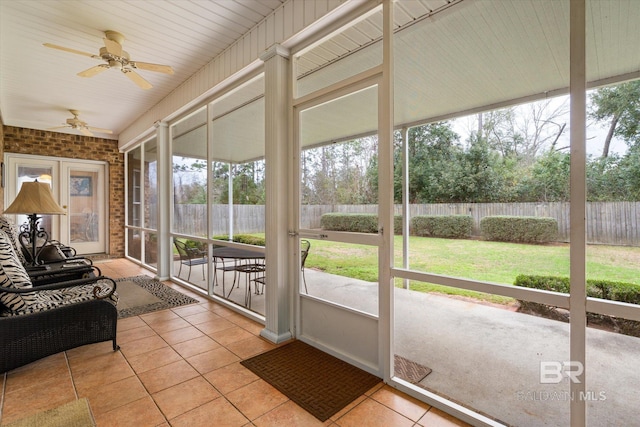 sunroom featuring ceiling fan