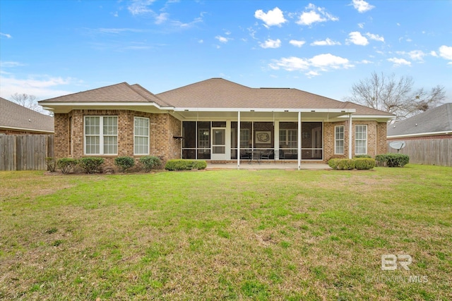 back of house with a yard, fence, and a sunroom