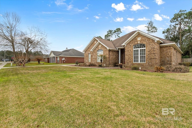 ranch-style house featuring brick siding and a front lawn