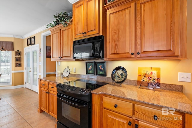 kitchen with light stone counters, black appliances, ornamental molding, and light tile patterned floors