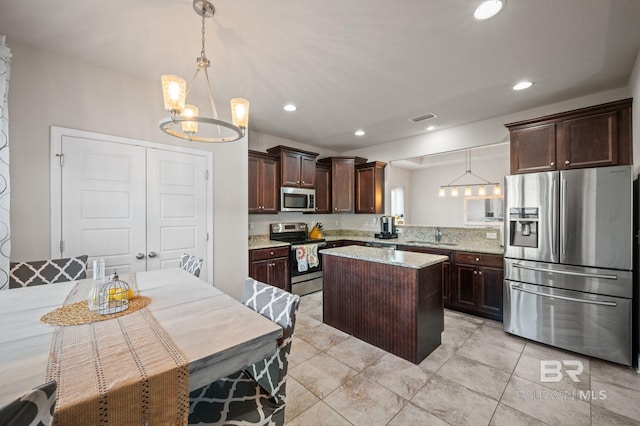 kitchen featuring a kitchen island, visible vents, dark brown cabinets, a notable chandelier, and stainless steel appliances