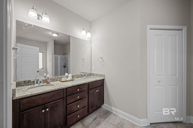full bathroom featuring baseboards, a sink, a stall shower, and tile patterned floors