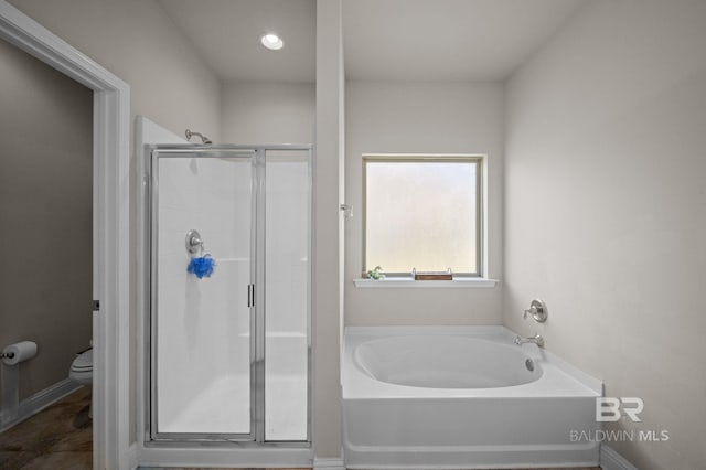 full bath featuring toilet, baseboards, a shower stall, and a bath